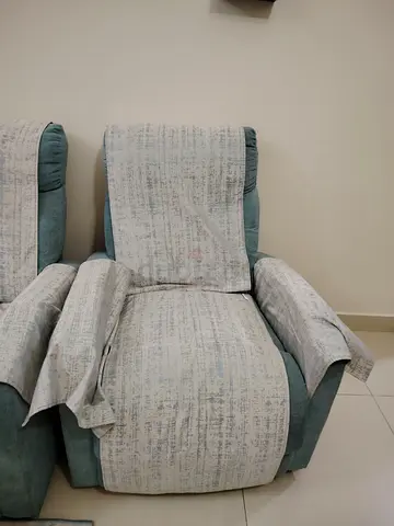 Teal reclining armchair with removable fabric protectors