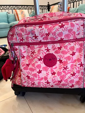 Kipling bags Pink rolling suitcase with wheels  and blue lightweight bag
