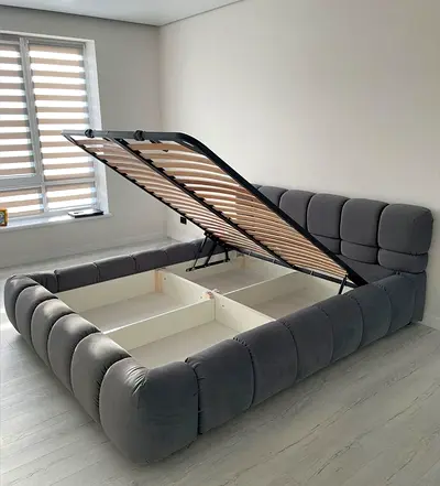Grey upholstered storage bed with hydraulic lift