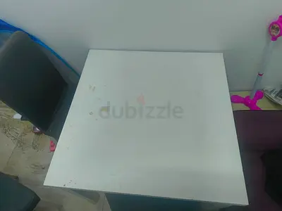 White Square Table with Signs of Usage