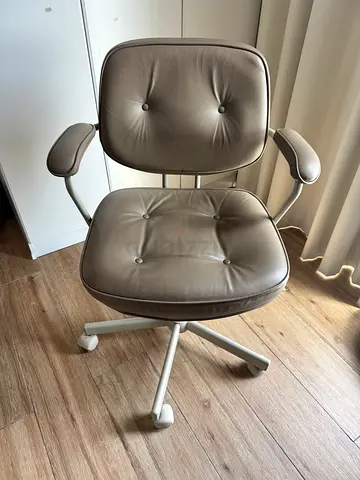 Beige padded swivel office chair on wheels from Ikea