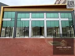 Shop + mezzanine for annual rent in Al Jurf 1 Ajman, opposite Al Aqsa School, good space, ceramic fl