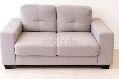 Grey 2-seater fabric sofa — used, good condition