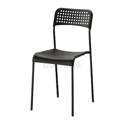 Black perforated plastic dining chair with metal legs