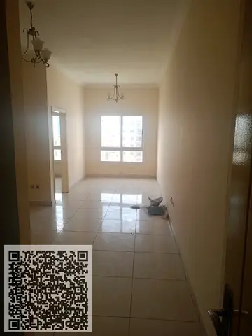 Two-bedroom apartment with a living room for annual rent in Al Nuaimiya 1, Ajman, opposite Al Hikma School, with free swimming pool and gym access.