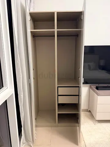 Beige tall wardrobe with 2 drawers and hanging rail - used