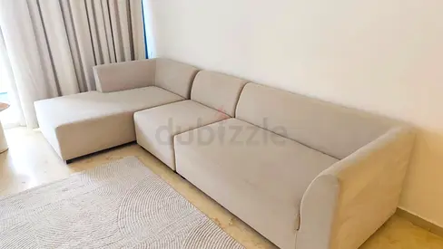 My beige L-shaped fabric sectional sofa with chaise. Needs a cleaning, there are stains.