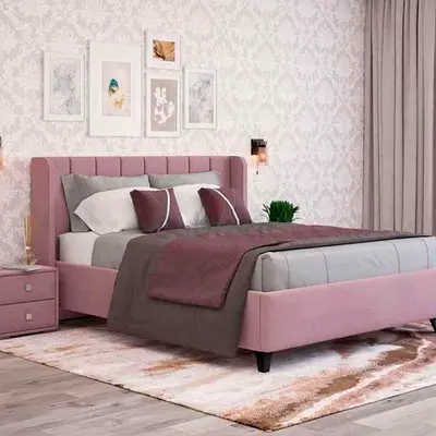 Pink upholstered double bed with padded headboard