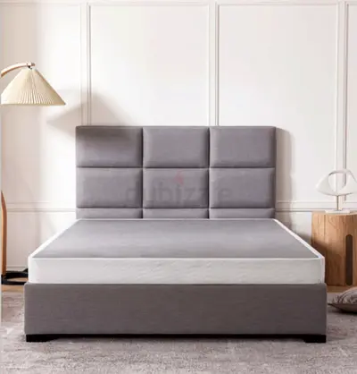 Grey upholstered King Size bed frame with padded headboard