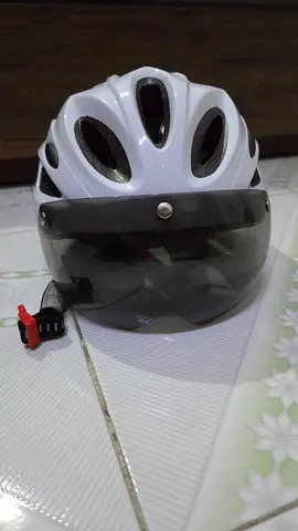 White bicycle helmet with tinted visor, used