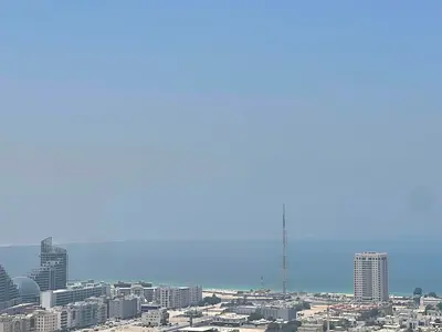 Beautiful balcony view – 4-bedroom master apartment with maid’s room. Free parking, central AC, gym, and swimming pool included.