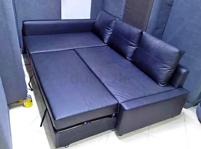 Black faux leather L-shaped sofa bed with  storage ikea