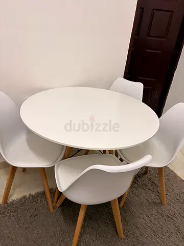 Small white round dining table with 4 chairs