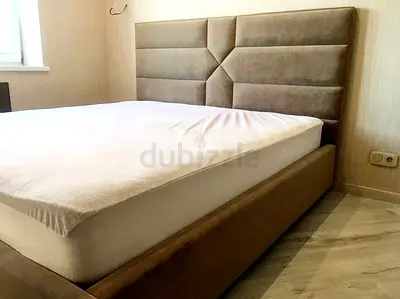 Brand New beige upholstered bed frame with padded geometric headboard