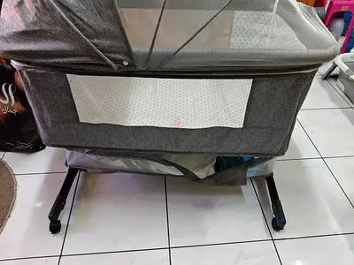 Grey bedside bassinet/portable crib with mesh side - good condition