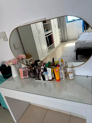 My makeup and skincare collection on vanity mirror — assorted products