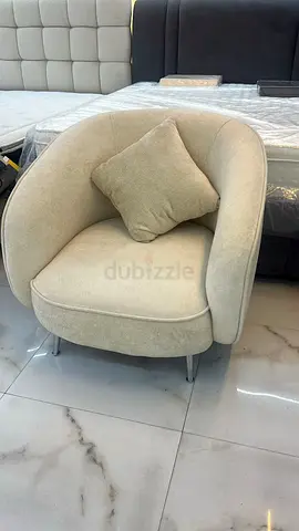 beige curved accent chair with cushion