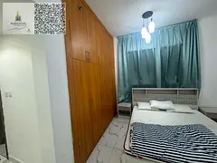 For annual rent in Ajman, Al Waha Towers, Al Rashidiya 1: a two-bedroom apartment with a living room