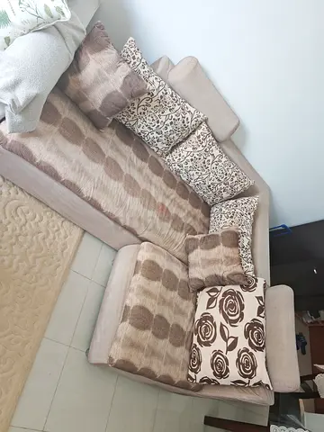 My beige L-shaped fabric sofa with chaise and cushions - gently used