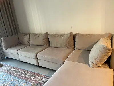 Selling my beige fully adjustable L-shaped modular sofa — 4-seater with chaise, good condition