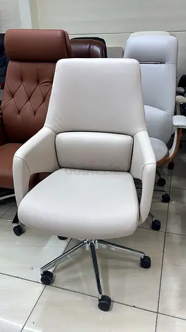 White leather swivel office chair with lumbar support