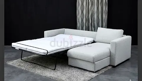 Light grey L-shaped sofa with chaise and pull-out bed