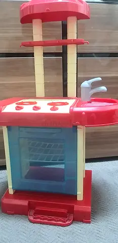 My kids red and yellow play kitchen set (stove  oven)