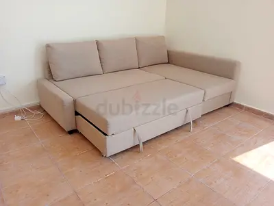Beige L-shaped sofa bed with chaise and pull-out storage (good condition)