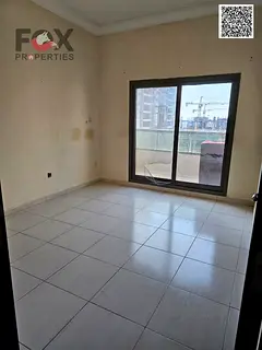 Two bedrooms and a living room for annual rent in Ajman, Emirates Towers, with a balcony and open vi