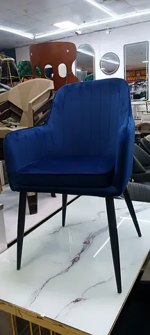 Blue velvet accent chair with black tapered legs