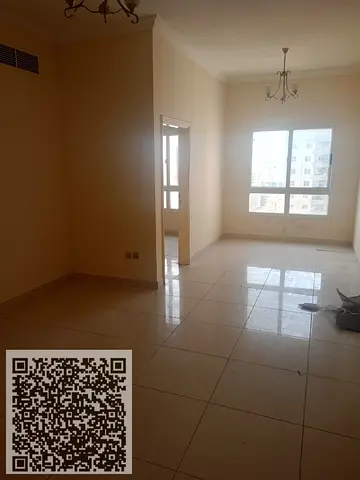 One-bedroom apartment for annual rent in Al Nuaimiya 1, Ajman, opposite Al Hikma School, with free swimming pool and gym access.