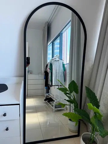 Large arched full-length black framed mirror