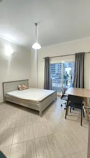 Master bedroom with attached bath and balcony in DSO Dubai Silicon Oasis.