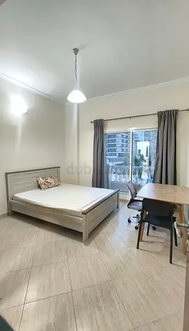 Master bedroom with attached bath and balcony in DSO Dubai Silicon Oasis.