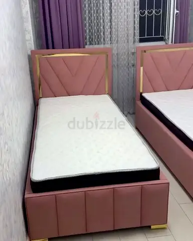 New Pair of pink upholstered single beds with mattresses