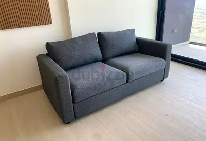 Grey 2-seater fabric sofa bed