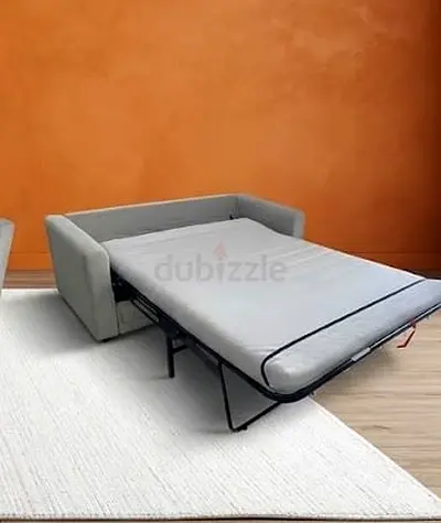 Grey fold-out sofa bed with mattress - clean and functional