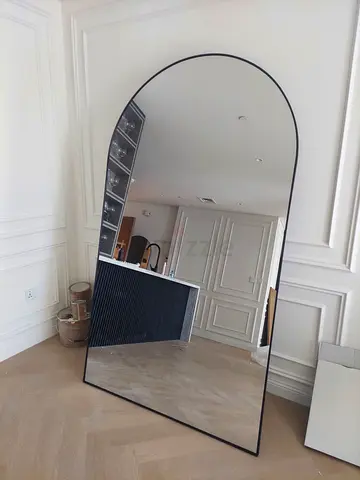 Large arched full-length leaning mirror with slim black frame