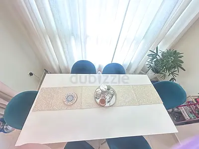 Elegant Dining Table with Stylish Green Chairs