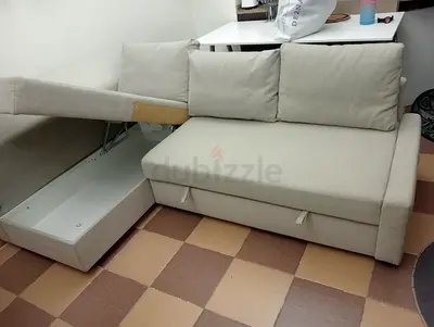 Compact beige sofa bed with storage - good condition