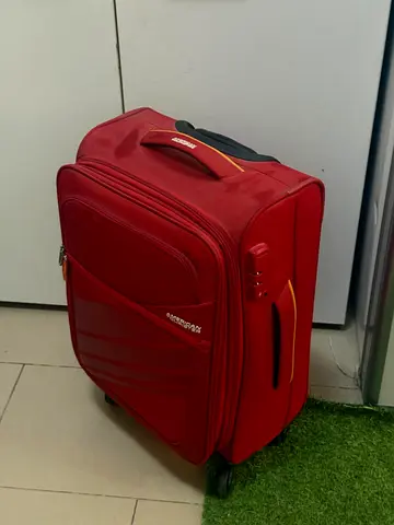 American Tourister medium red roller luggage - good used condition