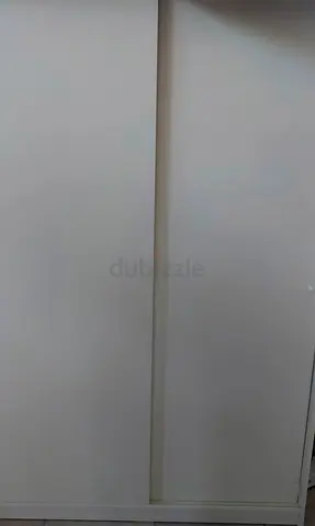 white sliding wardrobe (IKEA PAX-style) — compact storage