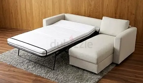L-shaped sofa bed with chaise — light beige, pull-out mattress