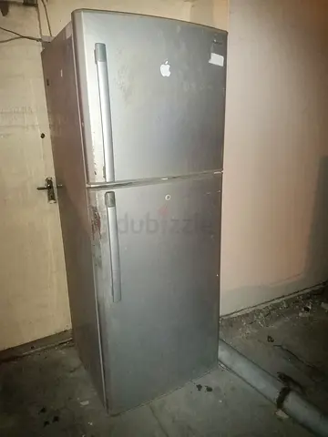 Used two-door refrigerator (top freezer) — selling as-is, may need servicing leaving country today