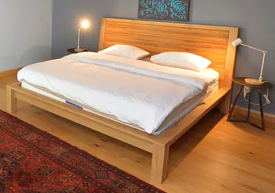 Solid wooden platform bed with headboard (natural finish)
