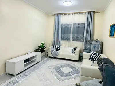 Cream sofas with ornate blue armchairs — living room set