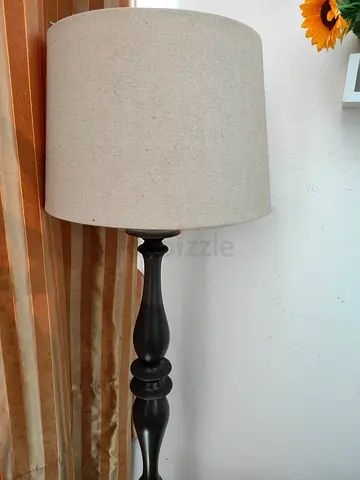 Black turned wood floor lamp with beige linen shade