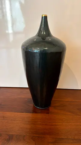 Tall glossy dark ceramic vase with gold accent