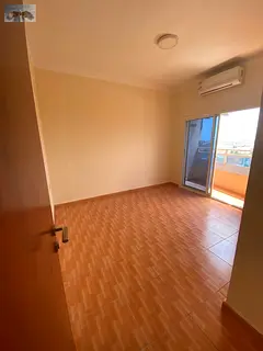 a one-bedroom apartment with a living room located in Al Rawda 2, near Sheikh Maktoum Street. The