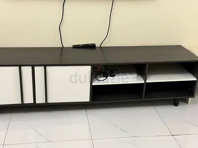 My TV console — dark wood with white sliding panels